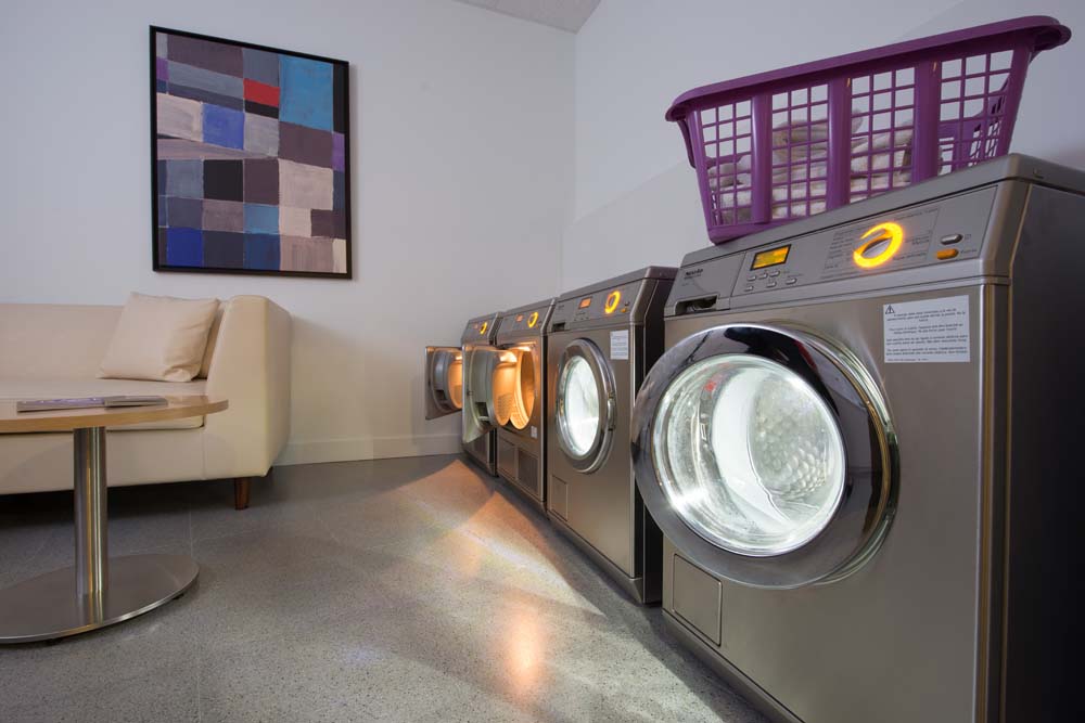 Self-service laundry suite at Carpi by Fraser, a family hotel in Barcelona