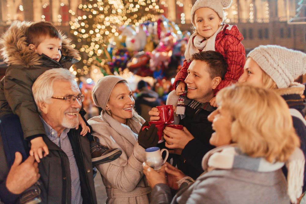 Photo of a cheerful family, celebrating Christmas Holidays on Christmas market