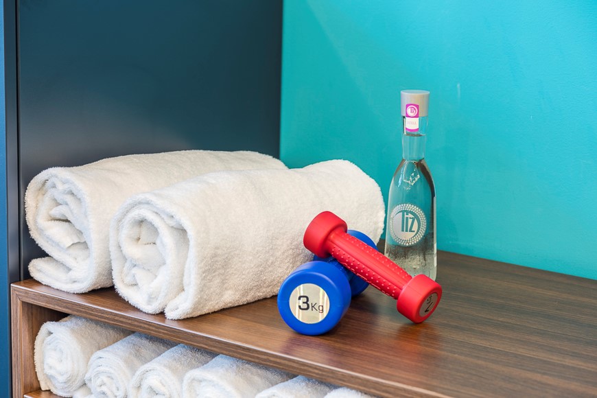 Towels & weights at fitness room at Capri by Fraser hotel with gym in Frankfurt