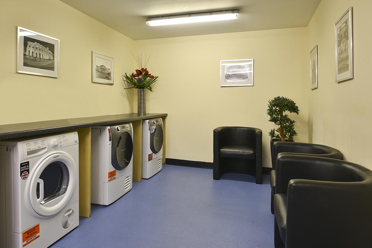 Overview of Self service laundry room at Fraser Suites Glasgow Servived apartments
