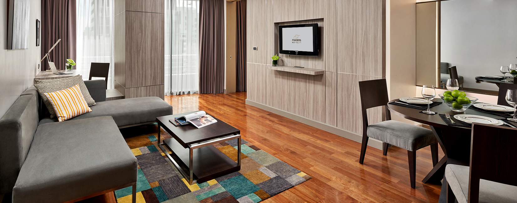 Dining area in One-Bedroom Premier suite with seating for three and contemporary furnishings