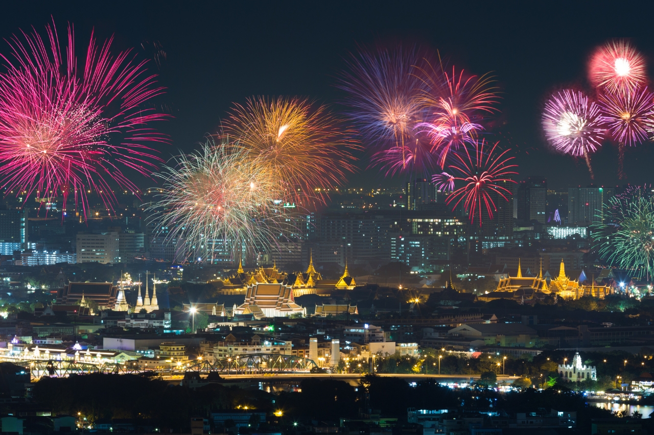 Colorful fireworks lighting up the night sky over Bangkok city
