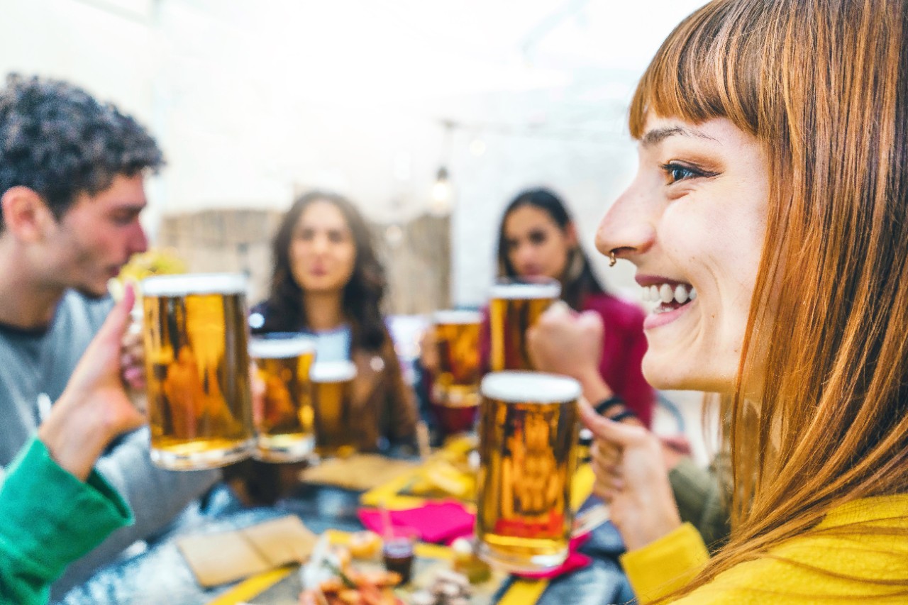 friends drinking and toasting beer at brewery pub