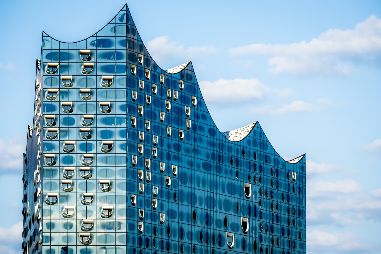 Stunning closeup of the famous glossy glass facade of the iconic Elbphilharmonie concert hall landmark in Hamburg