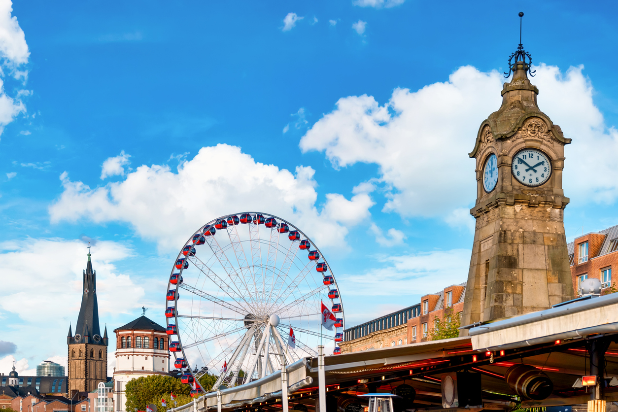 The historic water level clock and the Ferris wheel on the right bank of the Rhine in DÃ¼sseldorf's historic city centre