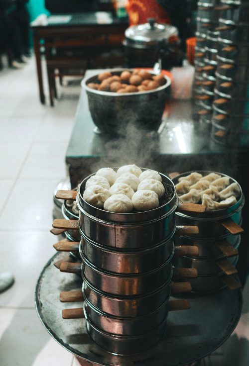 steamed soup buns alongside baskets of dim sum