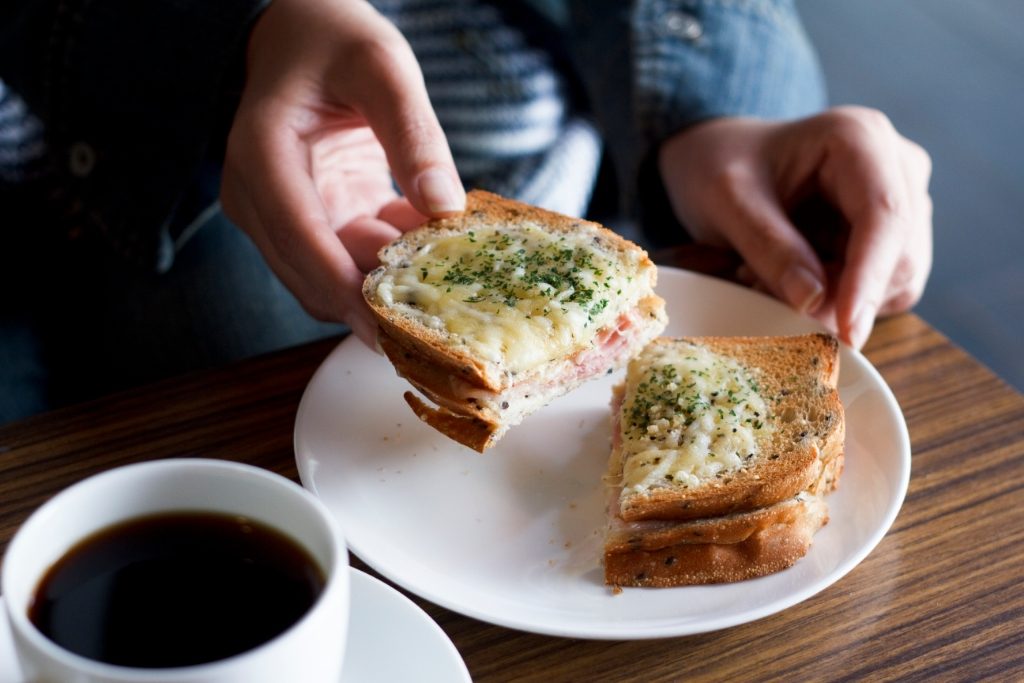 person eating croque monsieur