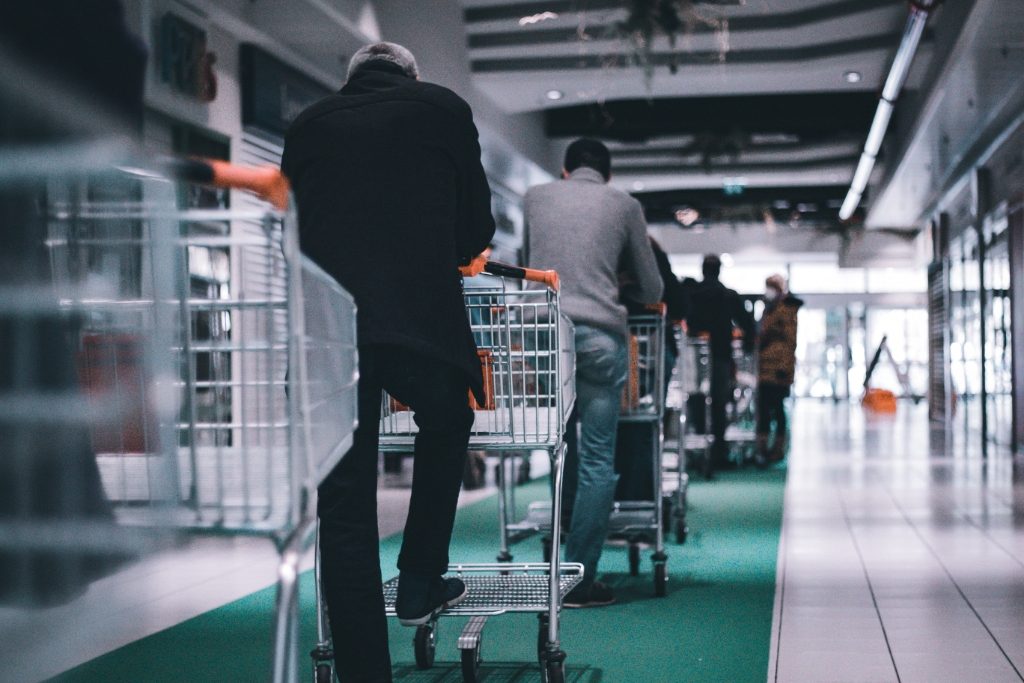 shoppers waiting patiently in a queue