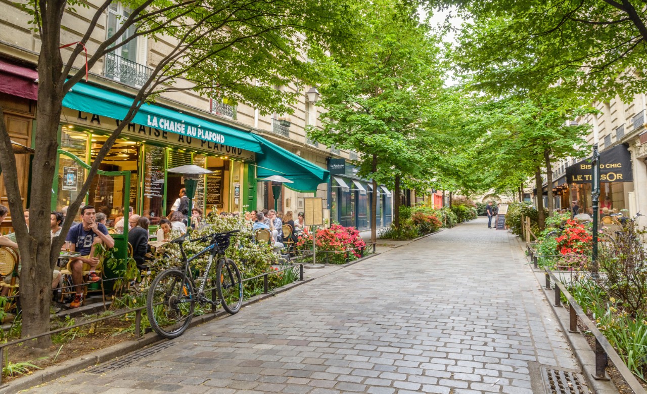 A quiet street with restaurants in the bohemian Marais district of Paris