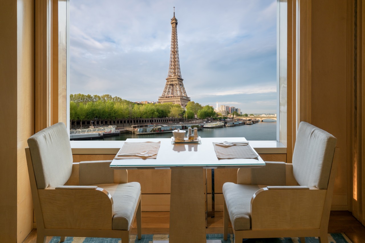 Modern luxury restaurant interior with romantic sence Eiffel Tower and Seine river view in Paris