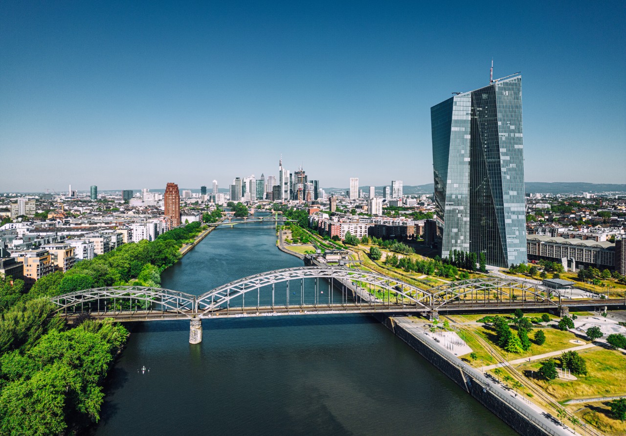 Aerial view of Frankfurt with the iconic EZB tower, under a clear blue sky.