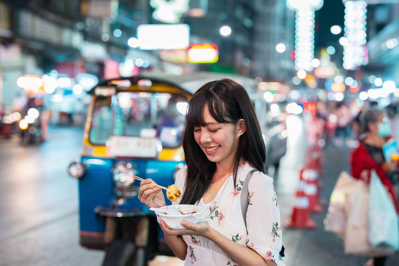 A woman enjoying Bangkok street food