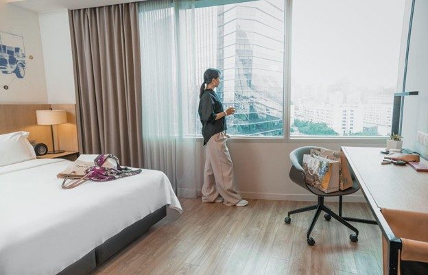 Guest relaxing in a modern hotel room at Modena by Fraser Bangkok