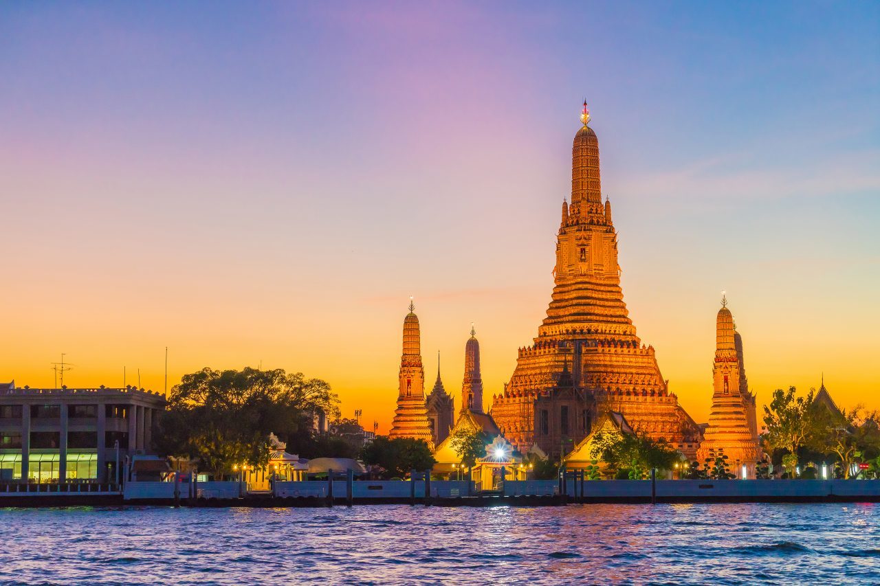 Wat Arun temple in Bangkok at sunset by the river