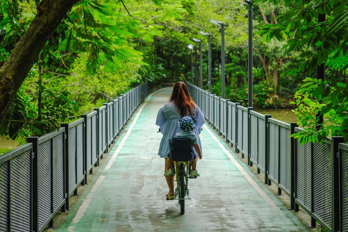 A girl riding a bike on a forest lane