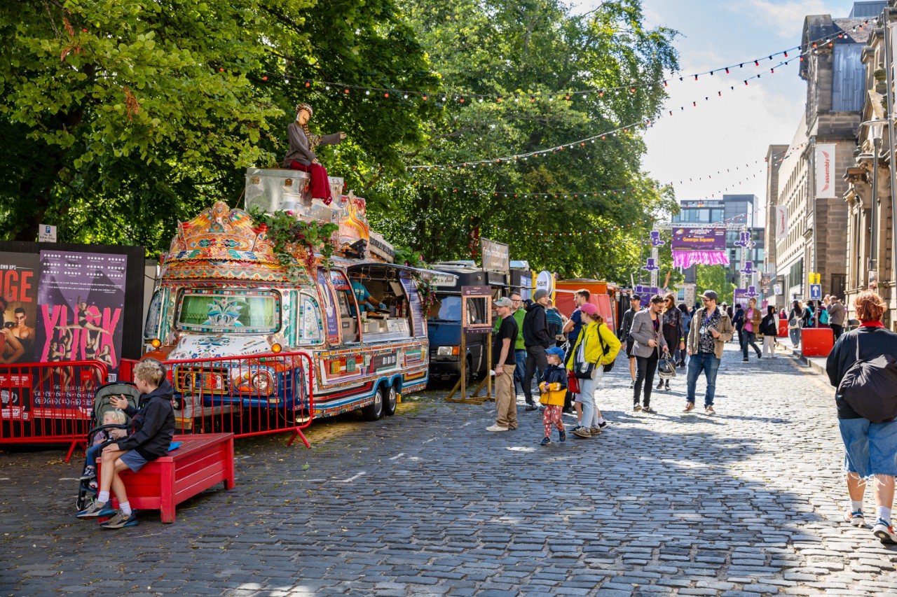 People walking in the streets with stands and artwork offer for sale during the Edinburgh Fringe Festival