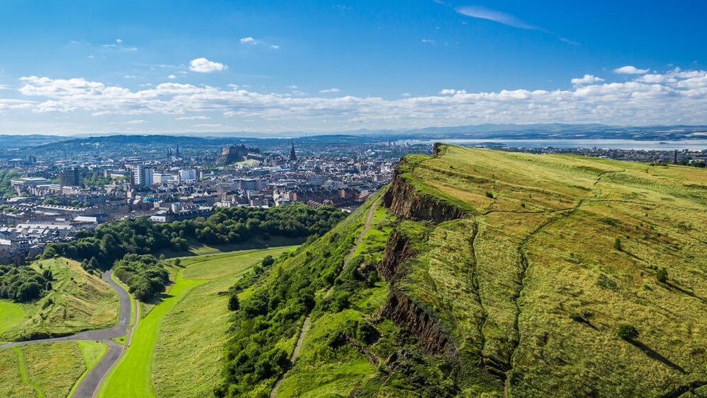 Family enjoy mulled wine at Christmas market in Edinburgh