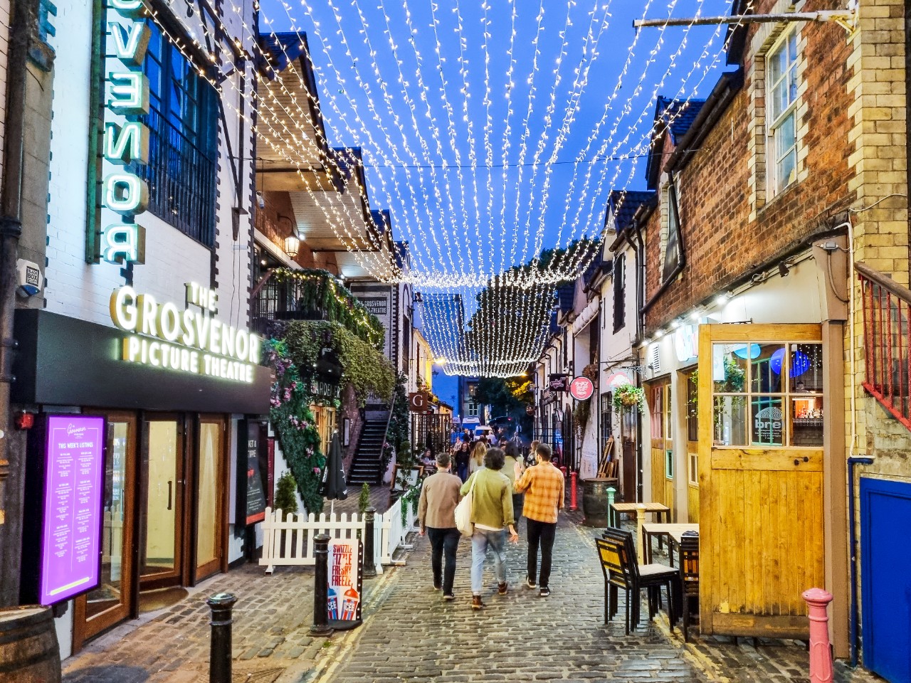 People walking on Ashton Lane, located by Byres Road in Glasgow's West End.