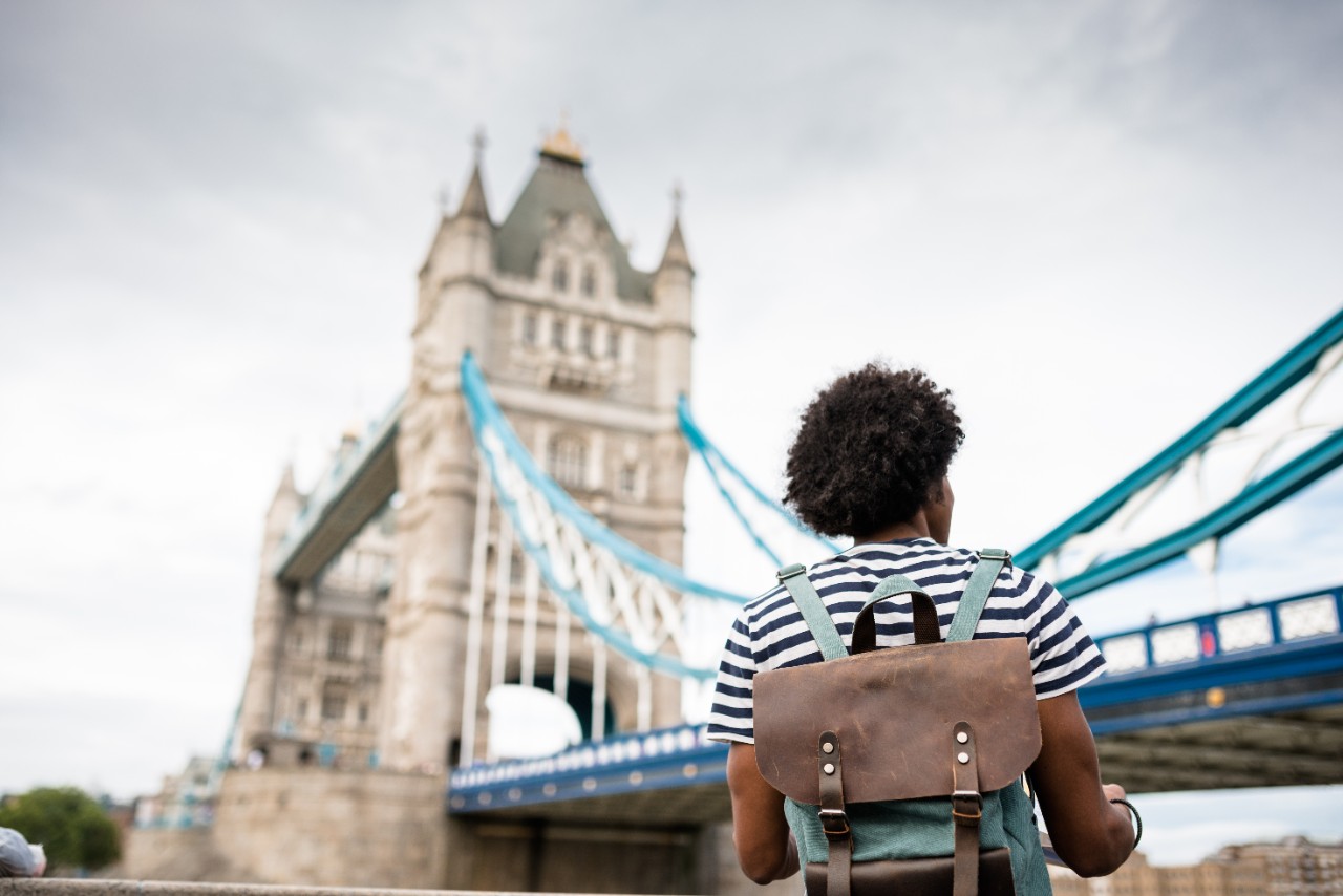 solo traveler in tower bridge area reading a map
