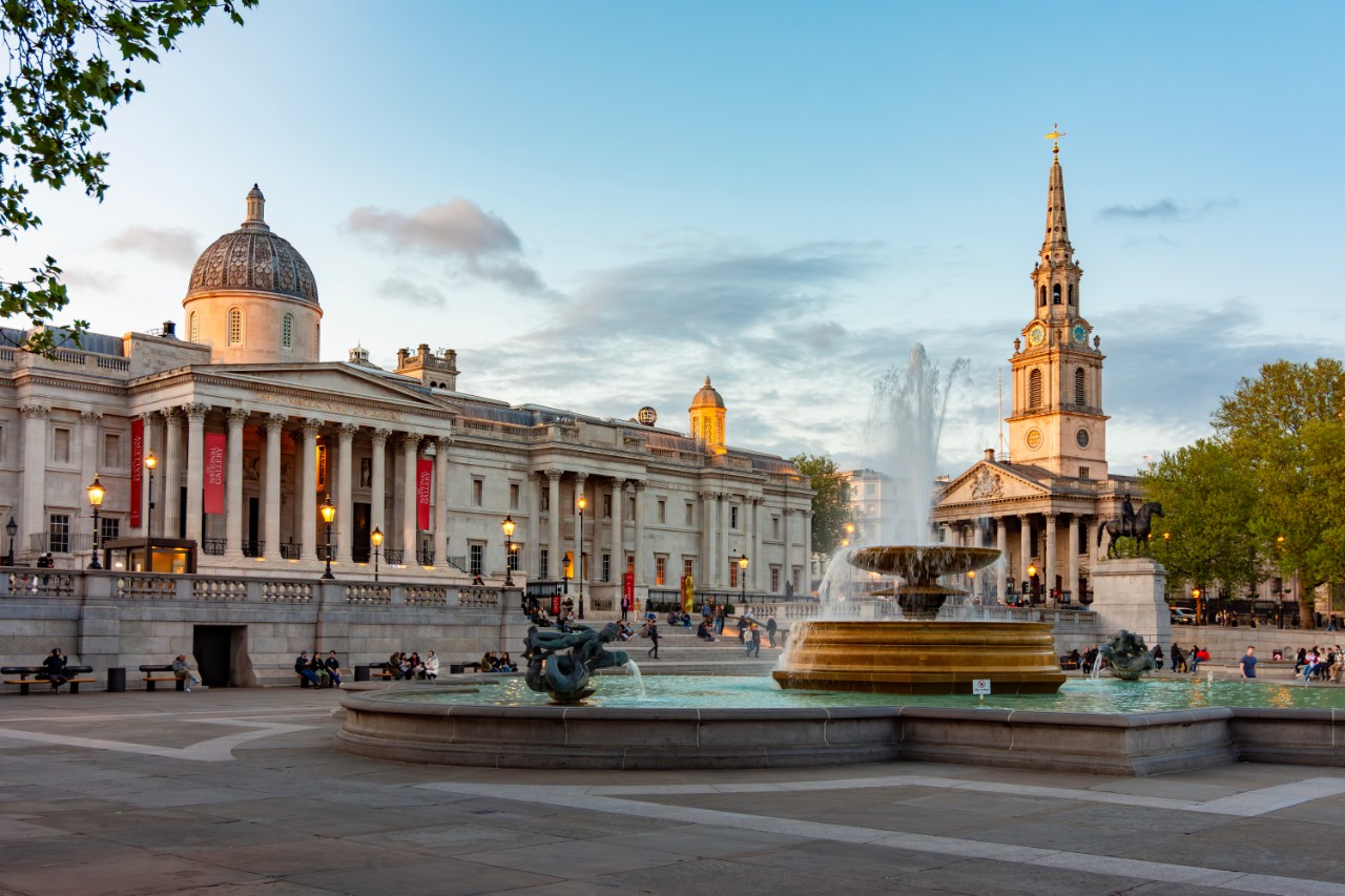 Fountain on Trafalgar square and National Gallery at sunset